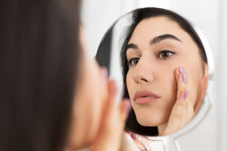 Girl Touching Face Looking In Mirror Indoor